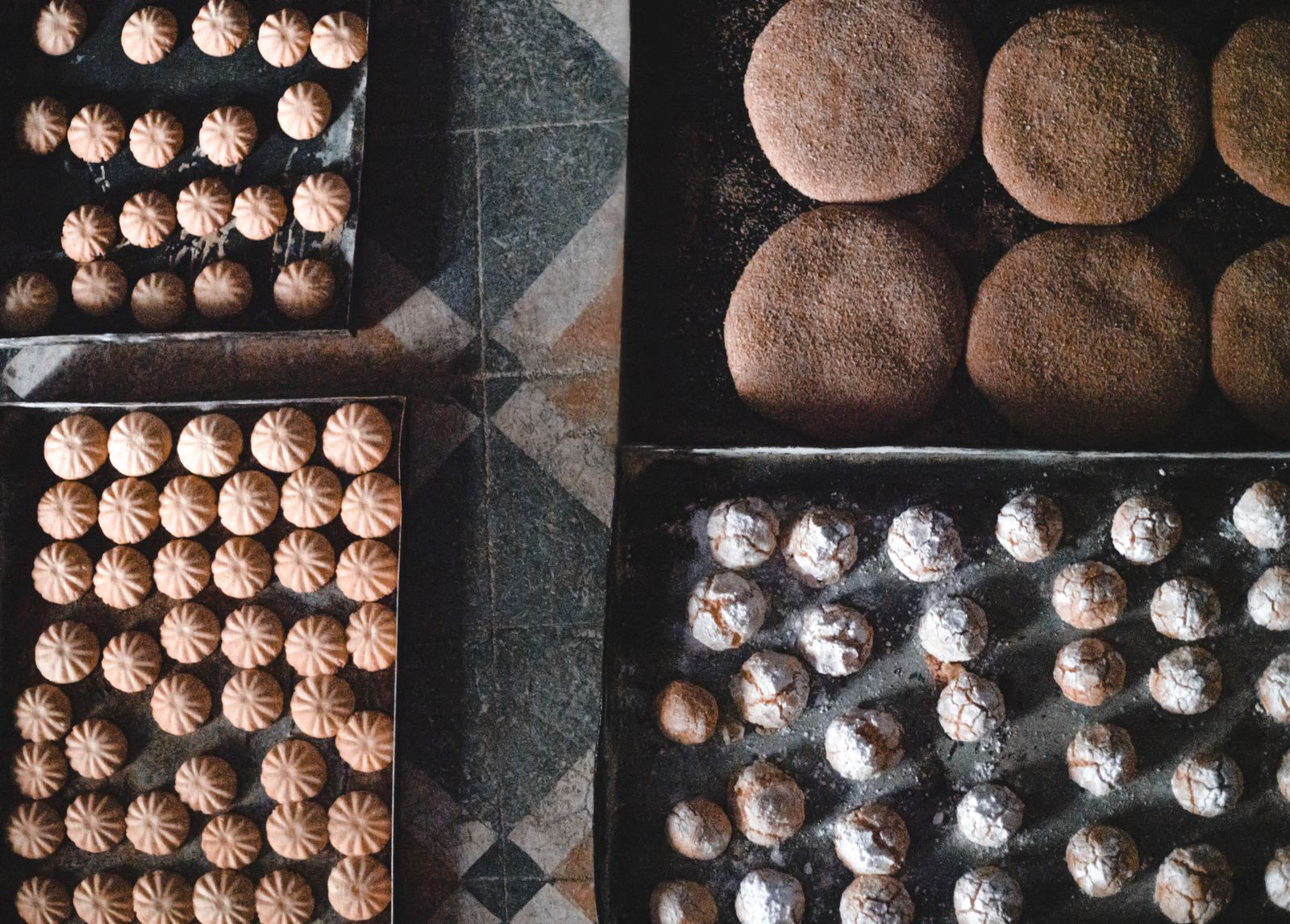 An assortment of traditional Moroccan pastries presented on trays.